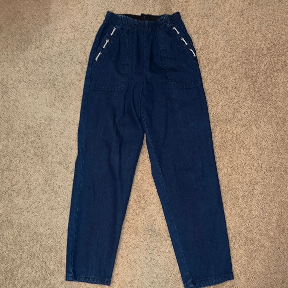 Jeans with elastic waist band and rope tied through the pockets